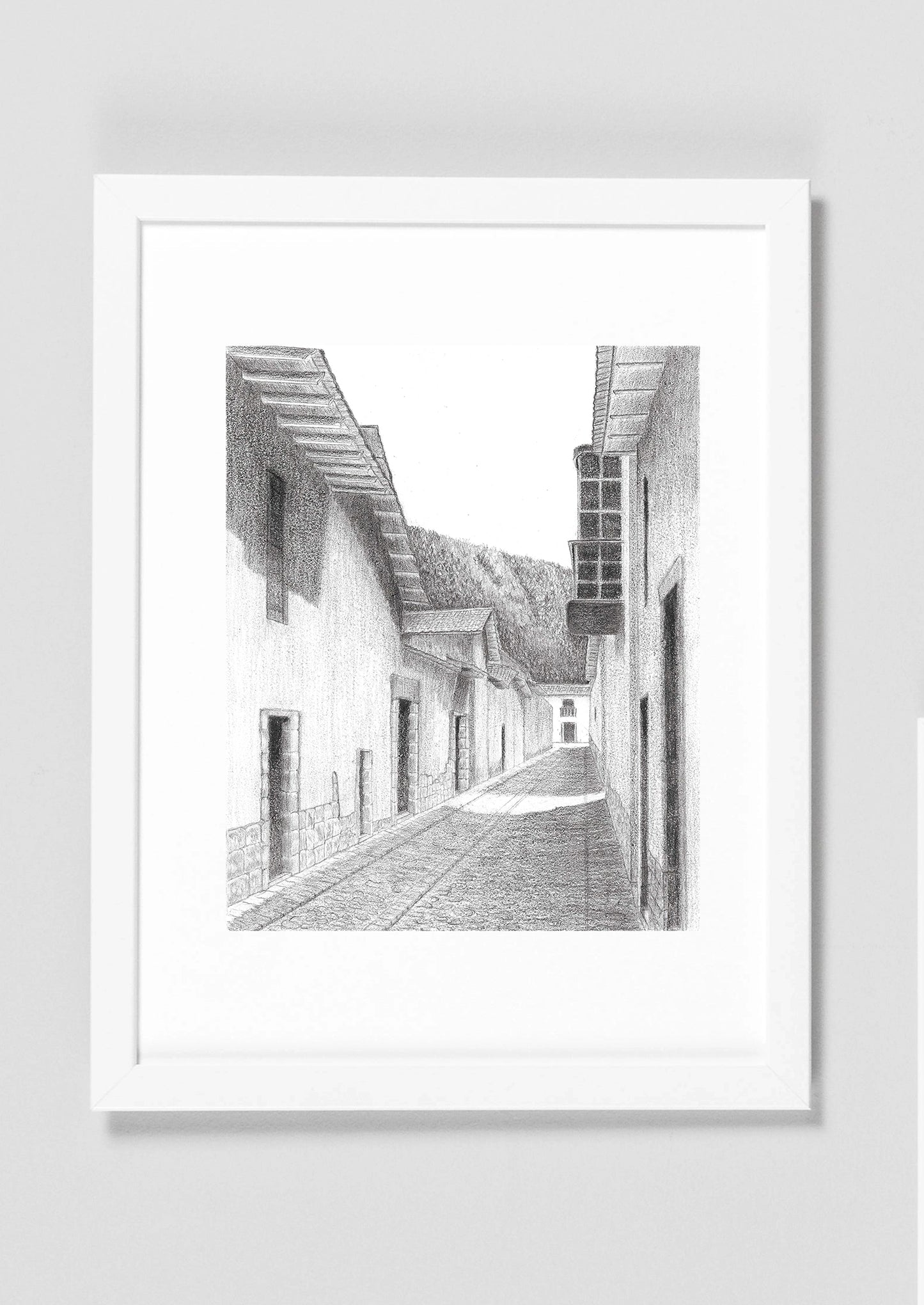 Mockup del barrio de San Blas en Cusco, imagen digital del dibujo en grafito, simulando enmarcado en blanco con paspartú blanco.