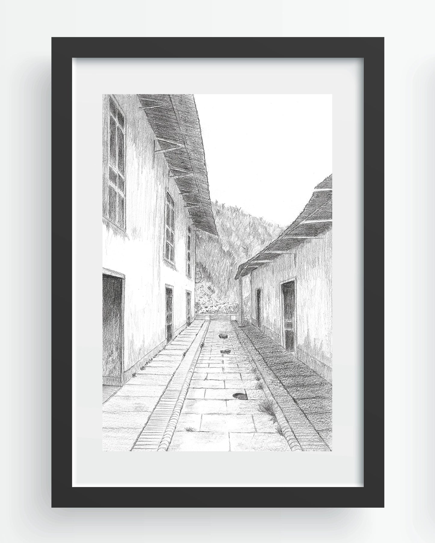 Mockup de Cajamarca, imagen digital del dibujo arquitectónico en grafito, simulando enmarcado en negro con paspartú blanco.
